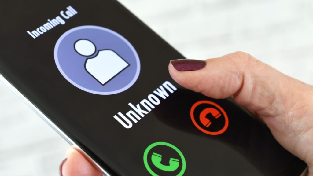 Close-up of a smartphone showing an incoming call from an unknown number from a possible fake lawyer