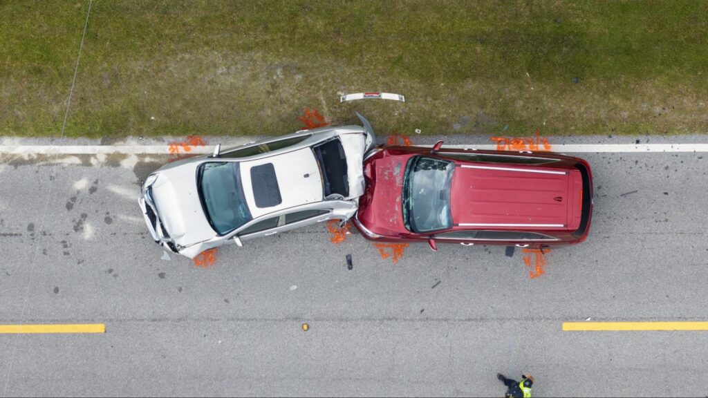 Aerial view of two cars in a traffic collision representing car accident victims targeted by fake attorney scams in Florida.