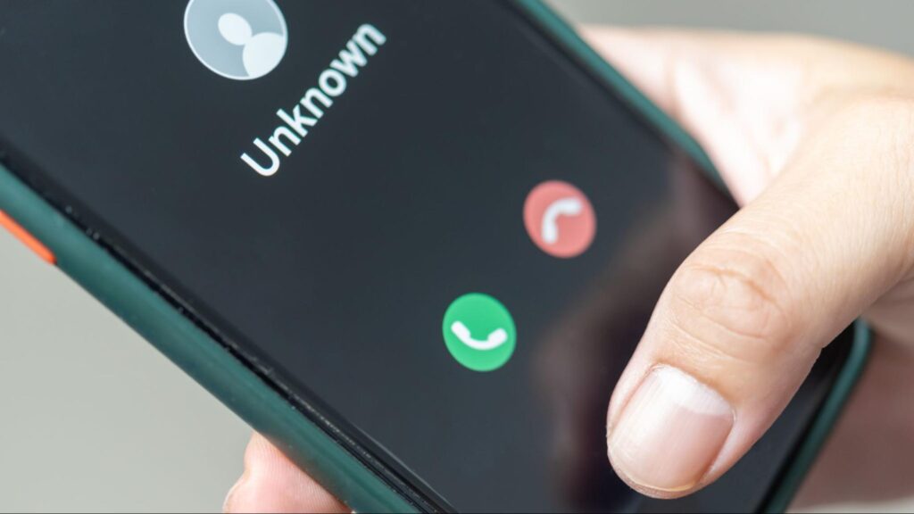 Person receiving a call from an unknown number, representing how fake lawyers contact accident victims in Florida.
