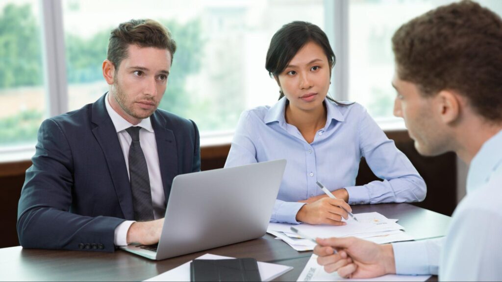 Team of Florida car accident attorneys meeting with a client to discuss legal help after a holiday crash.