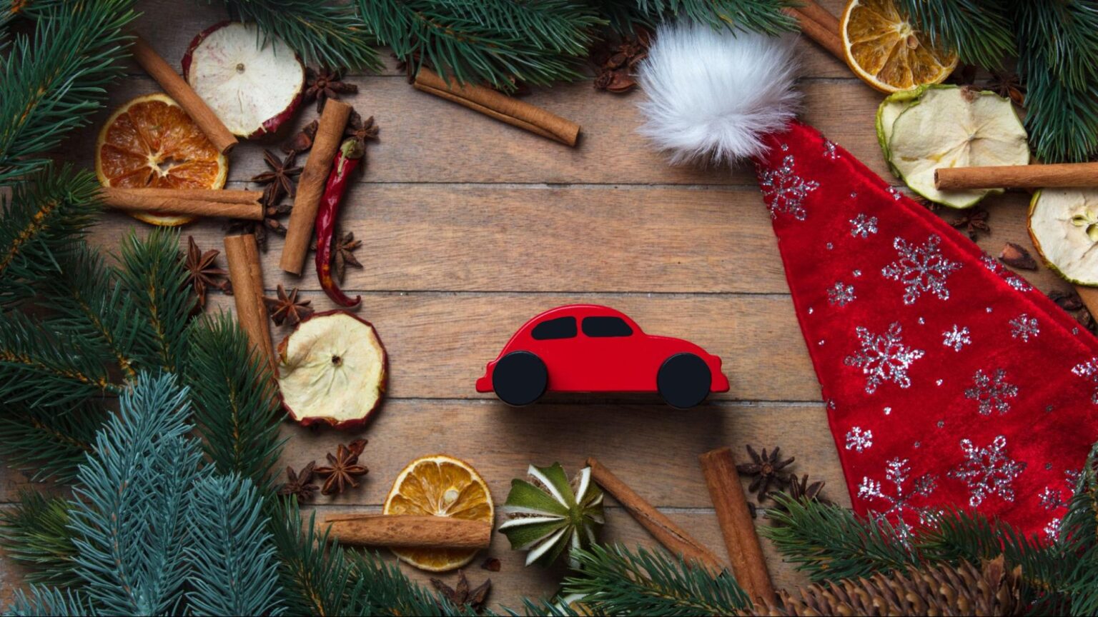 Holiday decorations and a red toy car symbolizing safe driving and car accident prevention during the holiday season in Florida.