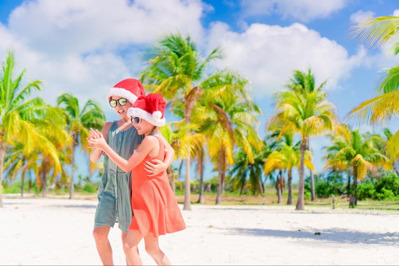 ouple Santa hats on a Florida beach during a high travel holiday season