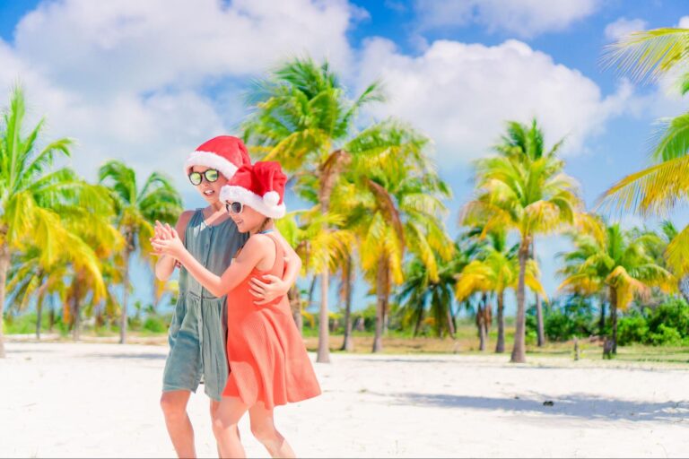 ouple Santa hats on a Florida beach during a high travel holiday season